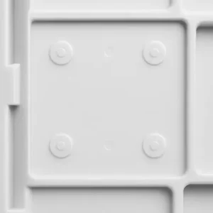 Close-up of ejector pin marks on an injection molded plastic part, showing multiple circular impressions caused by localized ejection force.