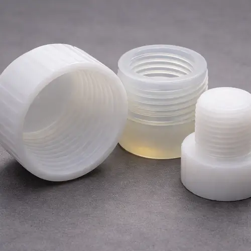 Real photo of plastic threaded parts showing a common undercut example in injection molding