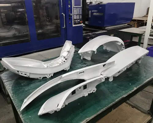 Custom plastic injection molded parts in workshop.