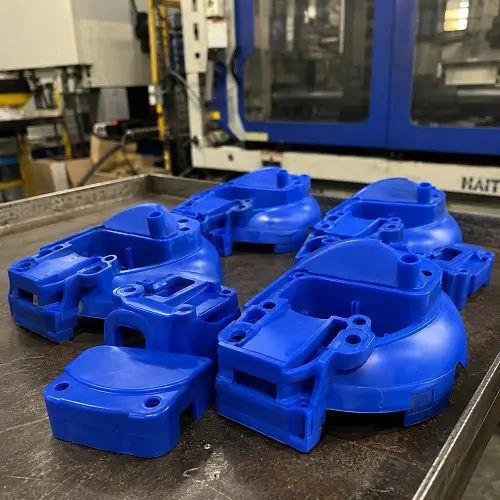 Blue injection molded plastic parts in a factory