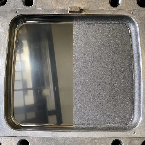 Mold cavity showing polished surface and VDI textured finish for injection molded parts
